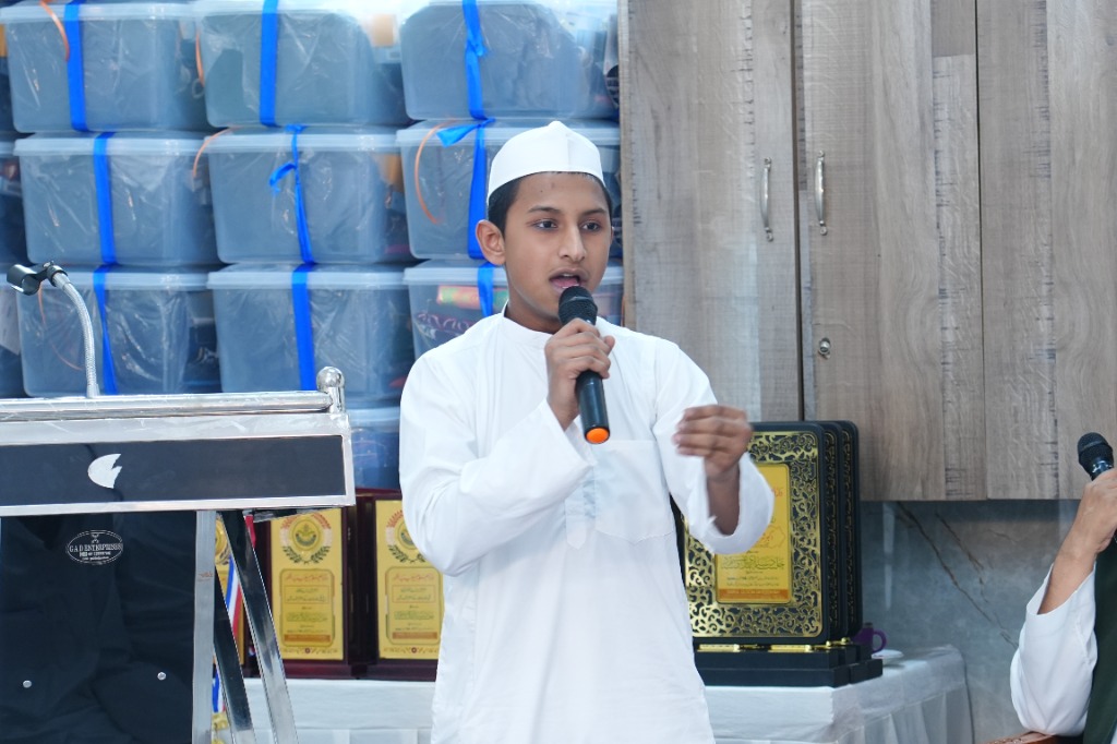 Student speaking on microphone representing Islamic Scholarship